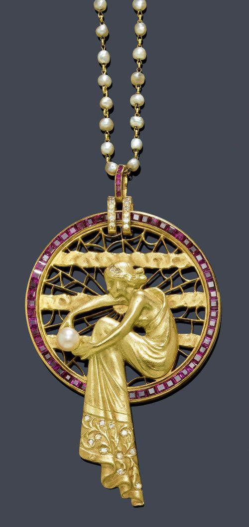 A PEARL, RUBY AND DIAMOND PENDANT WITH CHAIN, ca. 1940. Yellow gold 750. Highly decorative, round pendant after Masriera's "Lady of the lake" with appliqued figure of a seated nymph with pearls. The lower border of her flowing garments and hair are adorned with small diamonds. Open-worked background, decorated with stylized water wave, net and ray motifs. The frame is set with numerous carré-cut rubies and the double hinge is adorned with diamonds and carré-cut rubies. D 4.1 cm. Mounted on a delicate chain with numerous small Oriental pearls. L ca 63 cm.