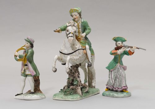 THREE-PART HUNTING PARTY,Nymphenburg, ca. 1900, 'Commissioned by the Prince Regent Luitpold 1913'. After a model by Frankenthal, comprising a horseman, a female hunter and a male hunter with a trombone. Hunting outfits in green and purple. Impressed faceted shield, impressed numbers, and inscribed in gold 'In aller H. Auftrag SKH des Prinzregenten 1913.' H 15 cm, 22 cm.