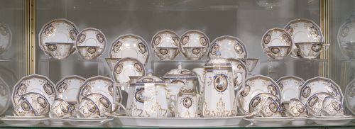 COFFEE SERVICE FROM THE 'BAVARIAN KING’S SERVICE',Nymphenburg, D. Auliczek model, ca. 1795, moulding 20th century. Comprising: 13 small cake plates, 12 mocca cups and saucers, 11 tea cups and saucers, 1 oval tray, 1 coffee pot and lid, 1 tea pot and lid, 1 sugar bowl and lid, 1 small milk jug. Lozenge shield printed and impressed. (67) PLEASE NOTE: there are 12 mocca cups and saucers and 11 tea cups and saucers.