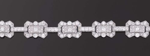 DIAMOND BRACELET, France, ca. 1925. Platinum. Decorative, elegant bracelet, the geometrically shaped links completely set with ca. 182 old-mine cut diamonds and octagonal diamonds totalling ca. 9.50 ct. L 19 cm.