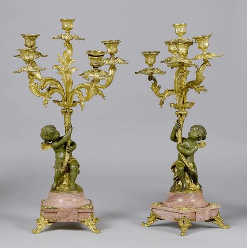 PAIR OF GIRANDOLES,Napoleon III, France. Bronze, partially gilt. Five-armed candle holder, designed as a leaf, on a shaft with putto figure. On a square marble base. H 57 cm.