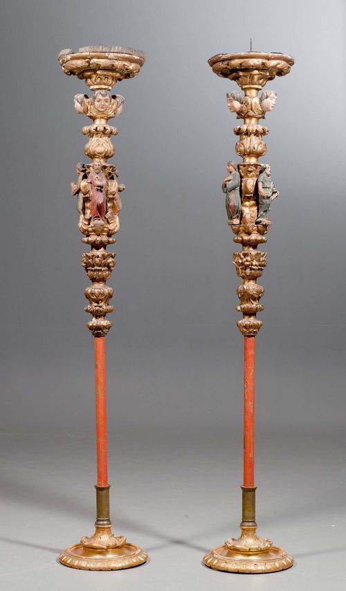 PAIR OF LARGE PROCESSIONAL CANDLE HOLDERS, Baroque and later, probably Spain. Carved wood with polychrome paint. Baluster-form candleholder with foliate carving, with figures of 3 saints and 2 angel heads. Large, round drip plate. and iron spike. H 199 cm.