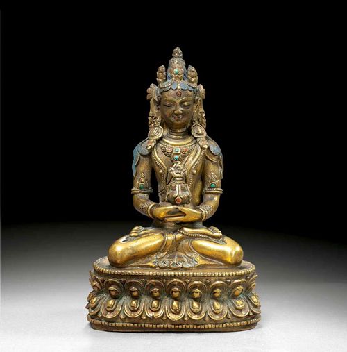 AMITHAYUS.Tibet, 19th century H 15.2 cm. Gilt copper alloy, with painted hair and face. The breast, arm rings and crown set with decorative glass stones.
