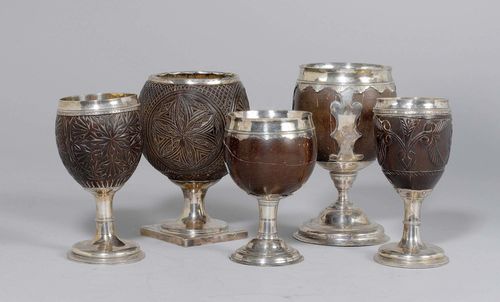 5 COCONUT GOBLETS,probably England, 18th/19th century. With various embossings. On a round silver foot, 3 coconuts carved with flower ornaments and birds. H 13.8 - 17 cm. Cracks.