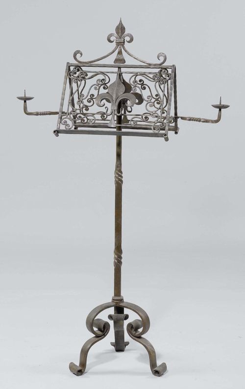 DOUBLE-SIDED MUSIC STAND,Historicism, France. Wrought iron. Open-worked with Fleur-de-Lys and 2 pivotable candle light arms on a square, partially twisted shaft and 3 volute feet. H 159 cm.