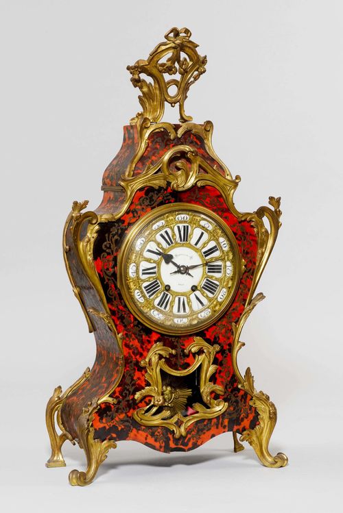 BOULLE CLOCK,Napoleon III, the dial inscribed VERHAGEN & CIE KÖLN. Wooden case with red tortoiseshell and inlaid with brass flowers and tendrils. Bronze mounts. Movement with anchor escape, striking the 1/2-hour on bell.  H 76 cm.