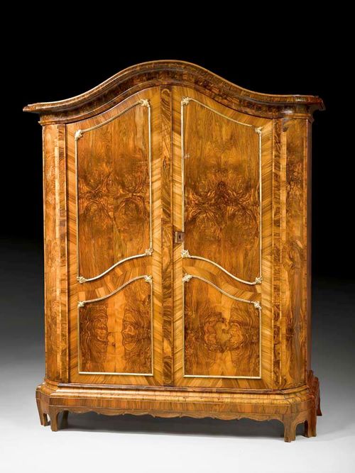 HALL CUPBOARD,Baroque, South German circa 1750. Walnut and burlwood veneer decorated with fine carved and gilt applications. With iron lock. Some losses. 186x76x225 cm. Provenance: from a German collection.