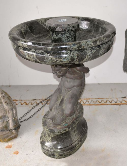 GARDEN FOUNTAIN, in the Baroque style, 19th century. Green/white veined marble and bronze. Putti seated on a dolphin. On a retracted, oval base. D 78 cm, H 124 cm.