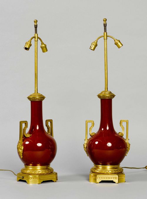 PAIR OF SANG DE BOUEF VASES AS LAMPS. Curved body with a narrow neck on a square plinth, decorated with laurel leaf band. H 71.5 cm. Fitted for electricity.