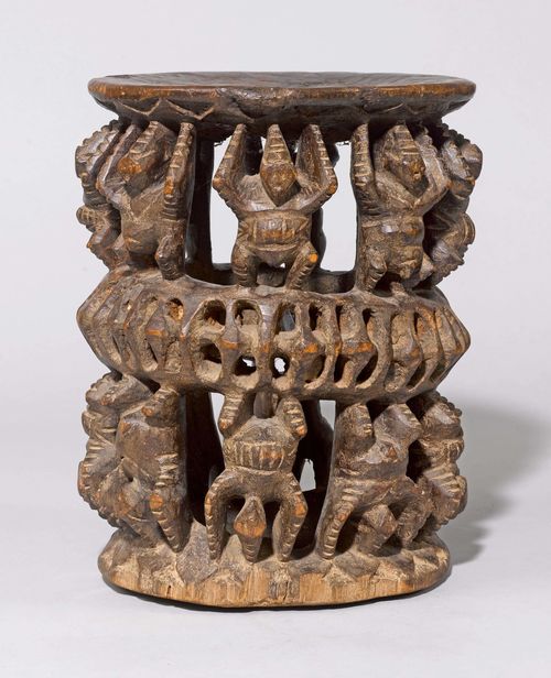STOOL,Africa. Carved wood. Pierced cylinder with 2 rows of circumferential figures. H 36 cm.