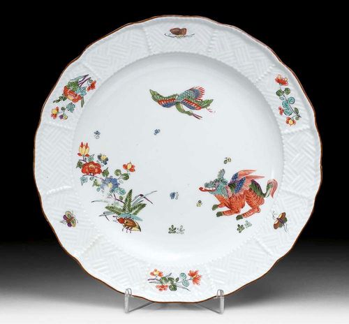 PLATE WITH 'KOREAN LION' DECORATION Meissen, circa 1740.The edge with 'Sulkowski' weave pattern relief. Additionally painted with peonies and Indianische Blumen and insects. Brown line. Underglaze blue sword mark, impressed number 61. D 23.5 cm. Somewhat rubbed. Provenance: from a Swiss private collection.