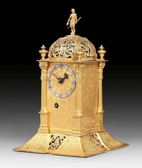 TURRET CLOCK,Renaissance, probably Augsburg, 17th century. Gilt bronze. Verso alarm disc and cut-out window with weekdays, planet symbols and figures of gods. Verge escapement with "Kuhschwanz" pendulum and striking hours on bell. 15x15x25 cm. Very good, restored condition.