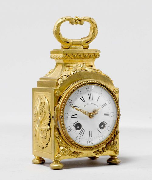 CAPUCINE,in the style of Louis XVI, France, ca. 1900. The dial signed PAUL GARNIER (Paul Garnier, deceased in 1917). Rectangular, gilt bronze case with retracted top and handle. Decorated with applied leaves and laurel branches. White enamel dial. Movement striking the 1/2-hour on bell. 9x6x15 cm. 1 key. Movement and striking mechanism require revision. Around 1900, Paul Garnier produced a fine collection of earlier clocks, of which 56 were donated to the Louvre in 1916. G.H. Baillie, Watchmakers and Clockmakers of the World. London, 1951. page 119.