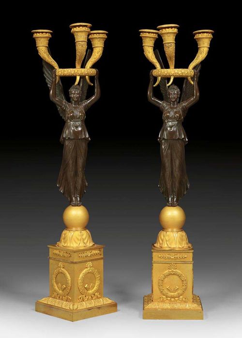 PAIR OF CANDELABRAS "AUX VICTOIRES", Empire, signed THOMIRE A PARIS (Pierre Philippe Thomire, 1759-1843), Paris circa 1810. Matte and polished gilt bronze. H 64 cm. Provenance: -Galerie Carroll, Munich. - From a very important German private collection. The candelabras offered here are illustrated in: H. Ottomeyer/P. Proschel, Vergoldete Bronzen - Die Bronzearbeiten des Spatbarock und Klassizismus, Munchen 1986; I, p. 331 (ill. 5.2.9).