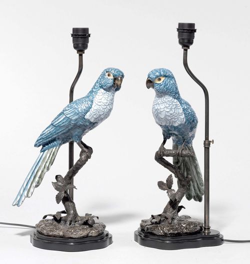 PAIR OF TABLE LAMPS WITH PARROTS,in the style of the 18th century. Porcelain, painted blue. Parrot sitting on a branch. 1 light branch, black fabric shade. On a round wooden base. H 75 cm. Fitted for electricity.