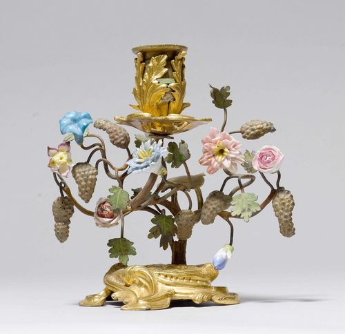 SMALL CANDLEHOLDER,France, Louis XV. Gilt bronze and porcelain. Shaft decorated with flowers and grapes. Leaf-shaped nozzle. On an associated plinth. H 13 cm.