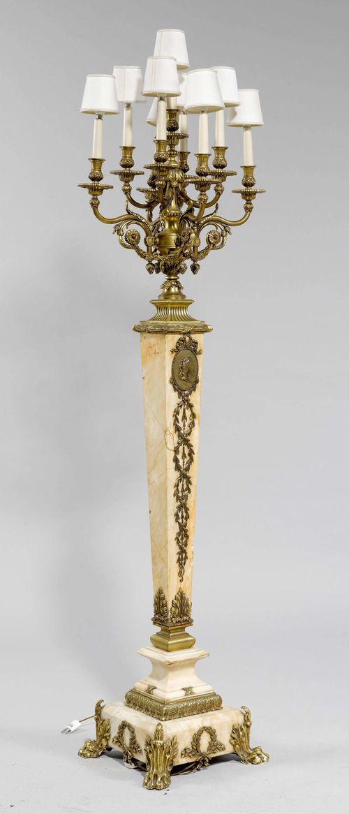 LARGE CANDELABRA,Napoleon III. Cream marble and bronze. Conical shaft with 9 curved light branches. Decorated with leaf frieze and grapes. Round drip pans and vase-shaped nozzles. White fabric shades. Stepped square base with paw feet. H 199 cm. Fitted for electricity.