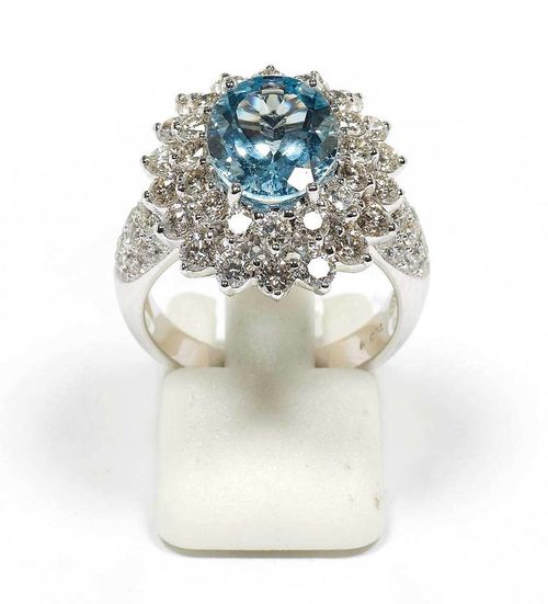 AQUAMARINE AND BRILLIANT-CUT DIAMOND RING. White gold 750. Elegant ring, set with 1 oval aquamarine of ca. 3.10 ct in a double surround of brilliant-cut diamonds totalling ca. 3.00 ct. Size 55. Matches the following lot.