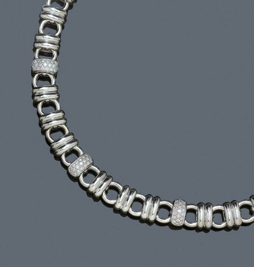 GOLD AND BRILLIANT-CUT DIAMOND NECKLACE, CHOPARD. White gold 750, 105g. Ref. 81//3348. Casual-elegant necklace with fantasy pattern of rings and circles, three links set with a total of 57 brilliant-cut diamonds totalling ca. 1.10 ct. Signed Chopard, Les Chaines No. 9194639, L 42.5 cm. With original case.