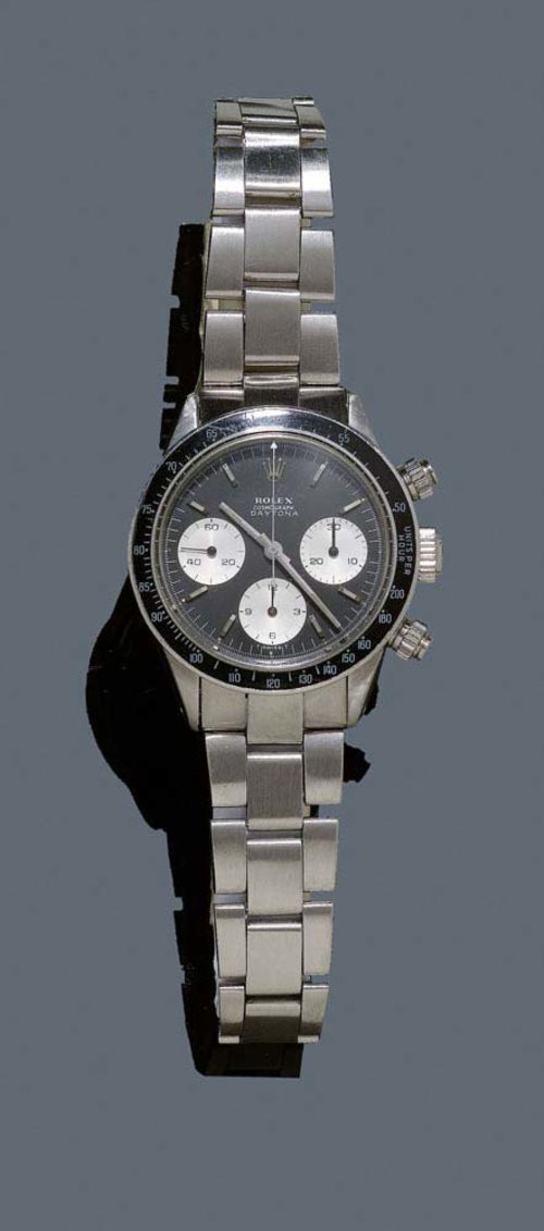 GENTLEMAN'S WRISTWATCH COSMOGRAPH, ROLEX DAYTONA, 1968. Steel. Ref. 6240. case No. 1439178 with screw-down back, crown and pushers. Black tachymeter lunette graduated to 200/h. Black dial with silver-coloured indices, light indices and light hands, signed Rolex Cosmograph, Daytona. Glass slightly scratched. Mechanical chronograph, hand winder, movement with Breguet spring and Microstella fine adjustment, Cal. 722, signed Rolex Genève. Original Oyster steel band, slightly bent. D 37.5 mm. With case, original invoice and instructions, 1968.