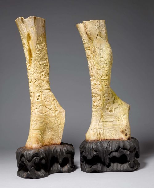 A PAIR OF ELEPHANT BONE CARVINGS WITH FIGURATIVE RURAL SCENES. Laos, Height c. 56 cm. Wood bases. (2)