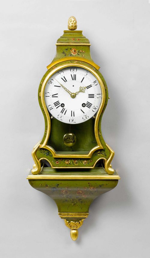 PAINTED CLOCK ON PLINTH,Neuchâtel, end of the 18th century. The movement signed N. GIRARDIN À LUXEUL. Wooden case, painted green and decorated with flowers. Enamel dial . Movement with verge escapement striking the 1/2-hour on bell. H 90 cm. Movement and case combined later.