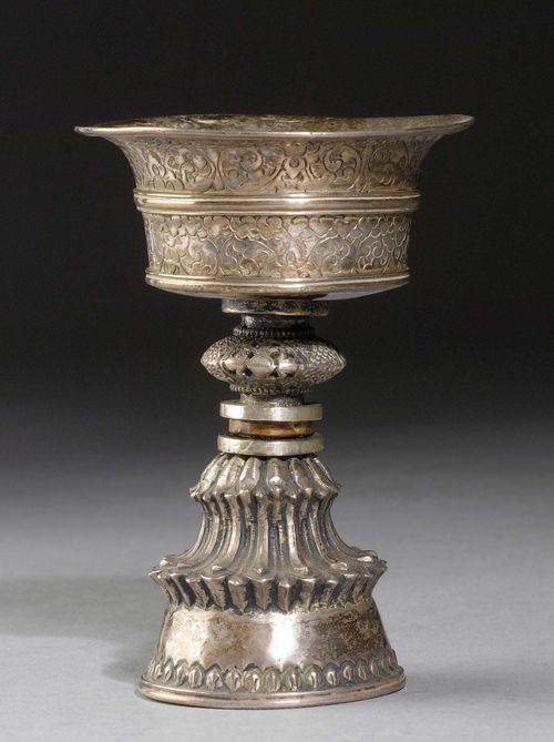A SMALL SILVER BUTTER LAMP ENGRAVED WITH FLORAL DESIGNS. Tibet, antique, height 11.7 cm. Copper ring around stem.