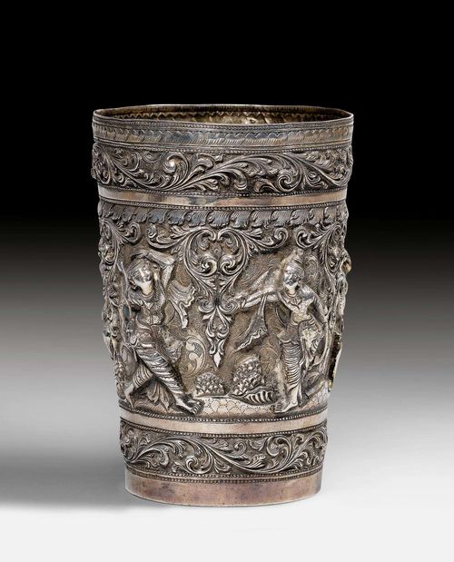 A CHASED SILVER BEAKER WITH A DESIGN OF FIGURES AMONG LEAFY SCROLLS. Burma, antique, height 12.5 cm.