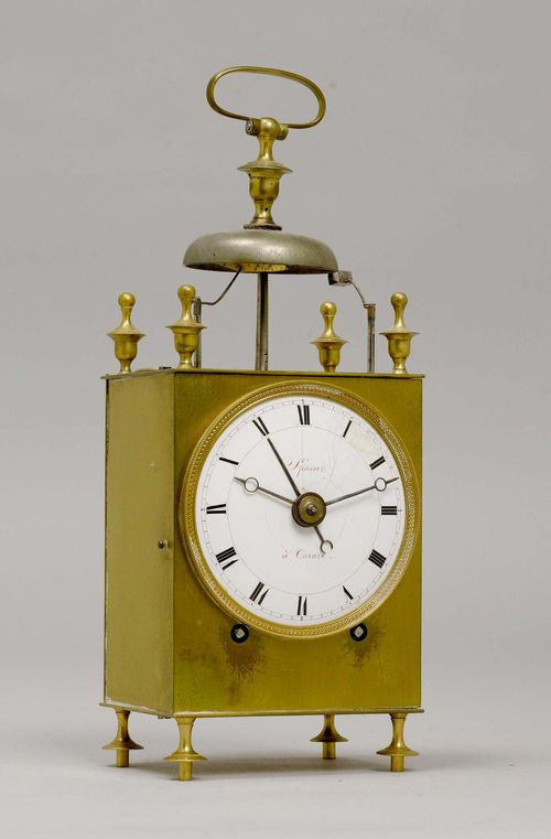 CAPUCINE, France, circa 1800. The dial signed "SPASSER À LA CACACE?". Brass case with external bell. White enamel dial (repaired). Movement with anchor escapement striking the 1/2-hour on bell. Repetition on demand. Alarm on bell. H 28 cm.