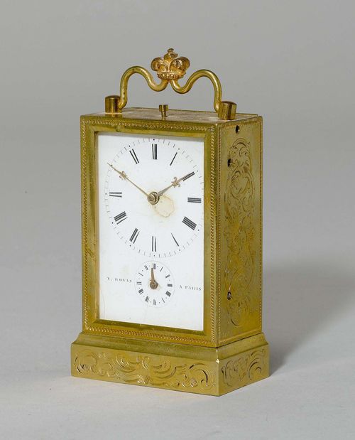 SMALL TRAVEL ALARM CLOCK,France, dial and movement signed "Y. ROVAS A PARIS". Brass engraved with tendrils and gilt. Rectangular case with white enamel dial with hour chapter ring and smaller chapter ring for the alarm. Movement with main spring. Alarm on the base of the case. H 11 cm. Dial damaged.