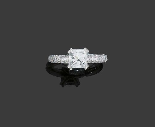 DIAMOND RING, F. LOHRI. Platinum 950. Elegant solitaire model, the top set with 1 Princess-cut diamond of 1.69 ct, G/VS2 in a double-prong chaton setting. The bar is additionally set with 68 brilliant-cut diamonds totalling ca. 0.85 ct. Hand-made, Size 51. Matches the previous lot. With GIA Report No. 13802359, December 2004. With copy of insurance certificate, March 2005.