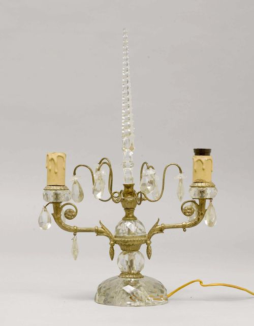 CANDELABRA, Napoléon III. Brass painted silver and cut glass. 2 light branches and drop-shaped glass ornaments. On a round foot. H 44.5 cm. Fitted for electricity.