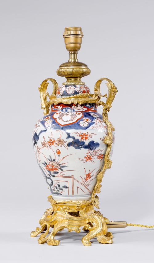 VASE AS A TABLE LAMP,France, 19th century. Convex, porcelain vase decorated with flowers in white/red/blue. Gilt bronze mounts. H 50 cm. Fitted for electricity.