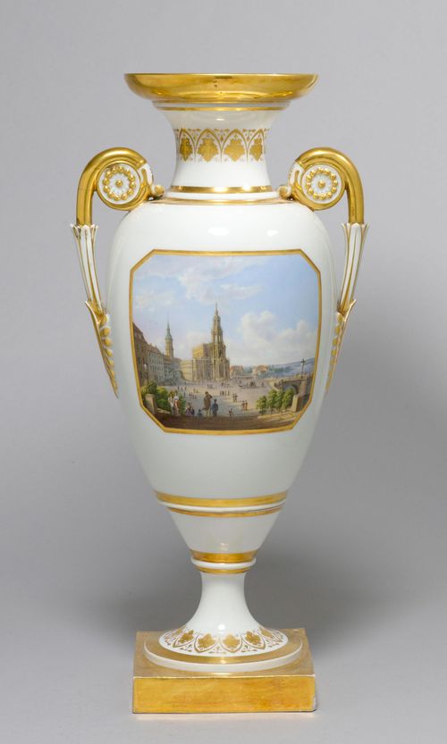 VASE WITH A VIEW OF THE DRESDEN CATHEDRAL,Meissen, ca. 1820/40. French Empire design with volute handles. With a view of Dresden and the Dresden Cathedral. In a rectangular gold frame. The back with a gold lyre motif. Underglaze blue sword mark. H 40 cm. 1 handle repaired. Provenance: - La Vieille Fontaine, Rolle.