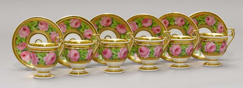 LOT OF 6 EMPIRE CUPS AND SAUCERS, France, ca. 1820/40. Each painted with rose borders on a golden ground. (12) Provenance: - from a private collection, Geneva.