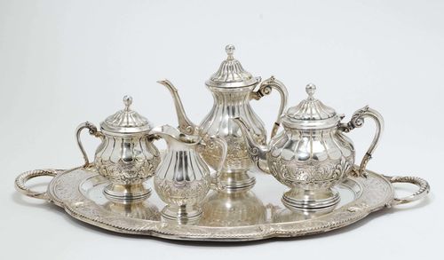 COFFEE AND TEA SET,South America, 20th century. Stepped, round foot. Gadrooned walls with decorative frieze. Curved volute handles. Comprising: coffee pot and tea pot, cream jug, sugar bowl and tray with handles. H of the coffee pot 24.5 cm, total weight 4000g.