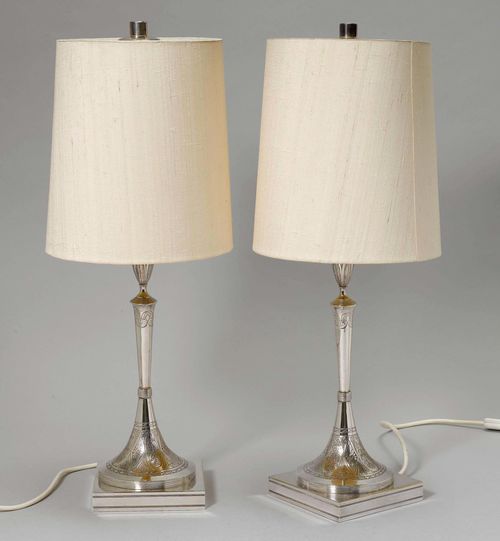 PAIR OF LAMPS WITH SILVER FOOT,Vienna, 19th century. With maker's mark. Square base, foot with floral decoration and monogram "ER". Matching shaft and nozzle. Fitted for electricity. H 61cm.