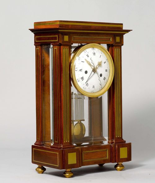 MANTEL CLOCK WITH DATE AND SECOND, Directory, Paris, ca. 1800. Mahogany, inlaid with brass fillets. Rectangular case, glazed on all sides. White enamel dial with bronze lunette indicating the hours in Roman numerals and the minutes and the date in Arabic numerals. Movement with pinwheel escapement, striking the 1/2-hour on bell. H 53 cm. Pendulum mount, defective.