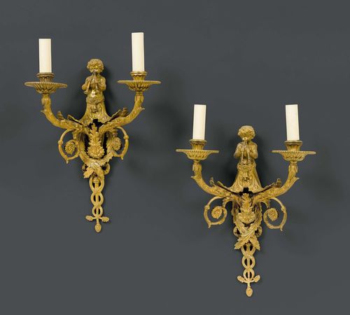 SET OF 4 SCONCES,Louis XVI style, France, 19th century. Gilt bronze. Pierced, with 2 curved light branches. Decorated with leaves, rosettes and a putto with 2 shalms. H 41 cm. Fitted for electricity.