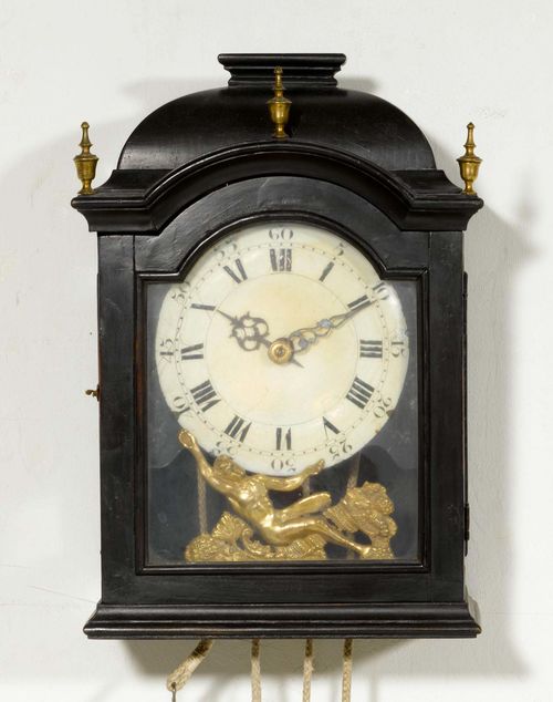 WALL CLOCK, Baroque, Neuchâtel, early 18th century. The movement signed "LES FRÈRES HUGUENIN, HORLOGERS DU ROI, CHAUX-DE-FONDS". Blackened wood with retracted top. White enamel dial (chipped). Verge escapement, and 1/2-hour strike on bell. H 40 cm. Glass door cracked. Alterations.