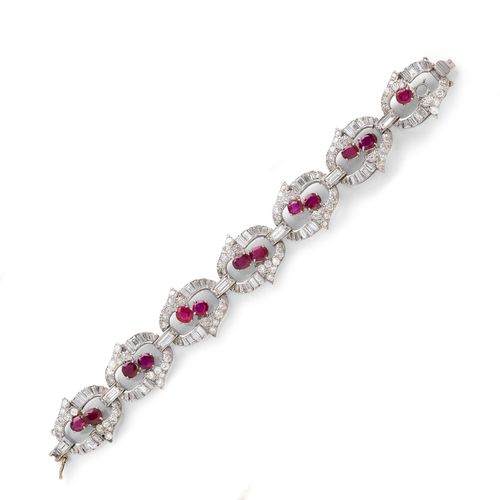 BURMA RUBY AND DIAMOND BRACELET, ca. 1960. White gold 375. Elegant bracelet with 7 oval links, each set with 2 oval Burma rubies, weighing ca. 6.00 ct in total, 1 synthetic ruby, 1 ruby missing, and each set throughout with 10 baguette-cut diamonds and 14 brilliant-cut diamonds, weighing ca. 7.10 ct in total, the intermediate links set with 6 baguette-cut diamonds weighing ca. 1.80 ct in total. L ca. 18.5 cm. With case. Oral short report by GGTL/Gemlab.