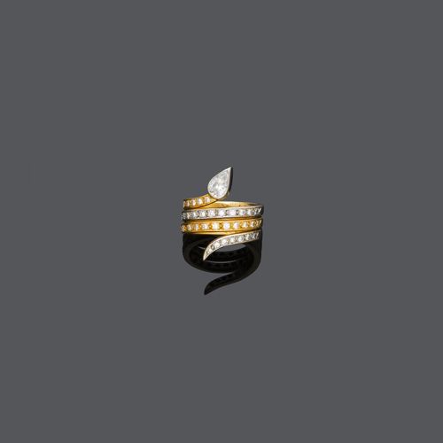 DIAMOND RING. Yellow and white gold 750. Designed as a coiled snake, set with 1 pear-cut diamond weighing ca. 0.70 ct and 41 brilliant-cut diamonds weighing ca. 0.60 ct. Size ca. 55.