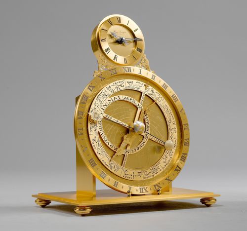 TABLE CLOCK WITH ASTROLABIUM,Hour Lavigne, Paris, 20th century. Brass and bronze. Small, round case with chapter ring mounted on top of a large astrolabium with orbiting moon. Mounted on a flat, rectangular base. Rectangular glass cloche. Battery-operated. 23x16x32.5 cm.