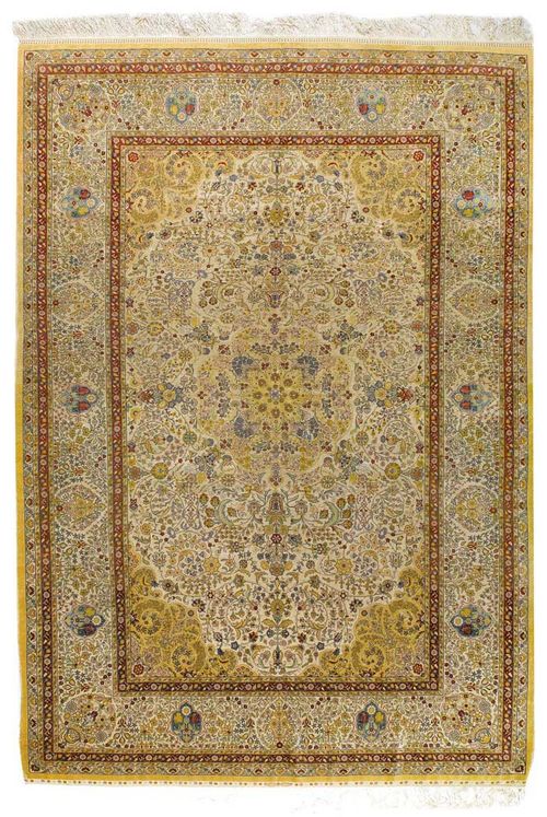 HEREKE old. Beige central medallion on a white ground with yellow corner motifs, the entire carpet is finely patterned with trailing flowers and palmettes in delicate pastel colours, white border, with signs of wear, 286x200 cm.