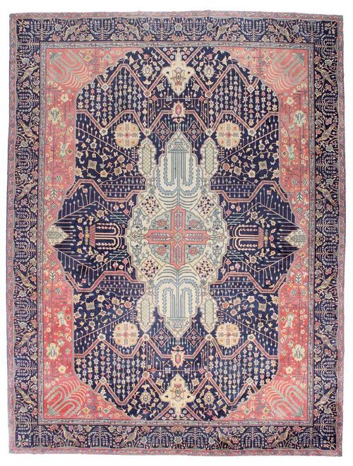 INDIAN, Feraghan design. Dark blue central field with rust coloured corner motifs and a light central medallion, the entire carpet is finely patterned with stylized plants in harmonious colours, dark blue border, good condition, 365x280 cm.