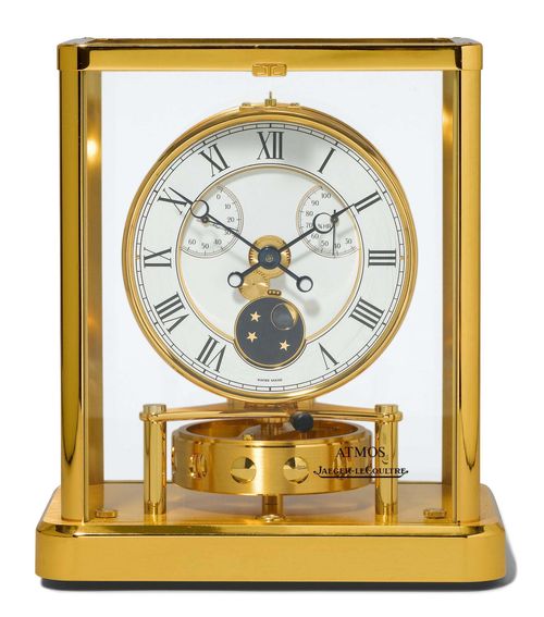JAEGER LE COULTRE CLOCK, "Atmos" model, ca. 1990 Gilt brass and glass. The dial with thermometer, hygrometer and moon phase. Movement number 674875. 20x15.5x32 cm. Small scratches on the dial.