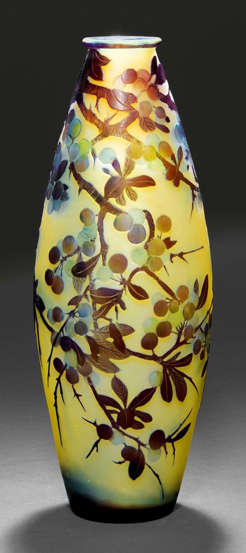 EMILE GALLE VASE, ca. 1900. Yellow glass with blue and purple overlay and etching. Cylindrical vase, decorated with cherries. Signed Gallé. H 38 cm.
