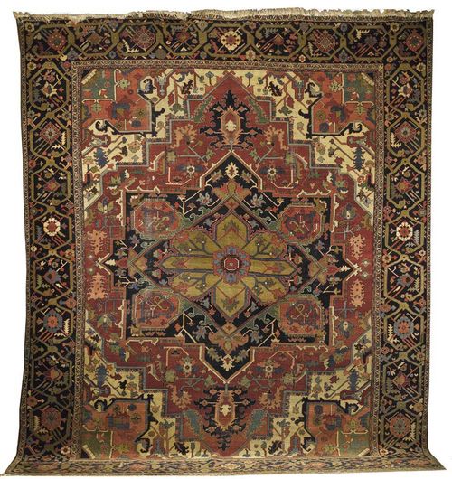 HERIZ antique. Large central medallion in red, black and green on white with pink corner motifs and black border. Some wear.  395x320 cm.