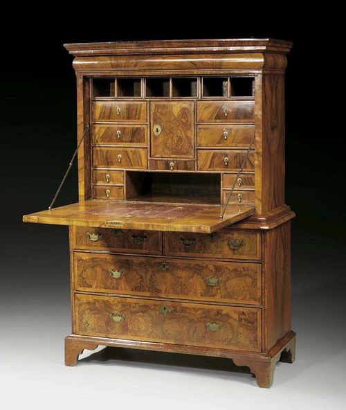 SECRETAIRE WITH "CUSHION DRAWER" George I, England circa 1710/30. Walnut and burlwood, moulded and in veneer, inlaid with fine fillets. Leather lined fall front writing surface over narrow drawer  and 3 further drawers, the upper drawer divided into two. The fitted interior with central compartment, drawers and sliding compartments and secret compartments. Brass mounts and drop handles. 112x49x(open 107)x169 cm. Provenance: Private collection, Lugano.