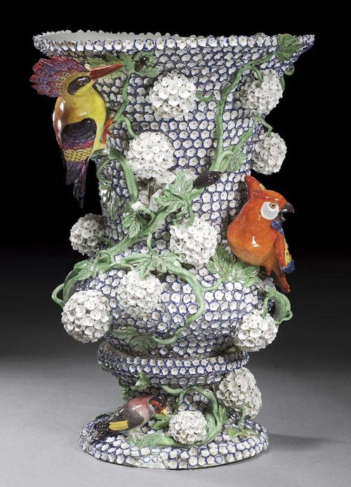 ‚SCHNEEBALLEN' VASE, probably Meissen, circa 1750, the decoration 19th century. After a model of J.J.Kändler with its formnumer 2767, densly applied with small white flowers edged in blue and with three parakeets and a jay bird, crossed swords in underglaze-blue, no form number incised, 48cm, restorations. Provenance: Private collection, Vienna.